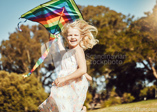 Image of Kite, running and girl run in an outdoor park with summer fun and smile. Nature, children vacation and happiness of kids in sunshine with freedom and smiling with energy on green grass feeling young