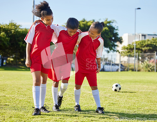 Image of Soccer, injury and children team help, support and walk with hurt friend during game at a sports field. Sport, accident and kids football group helping girl player after fitness, training and match