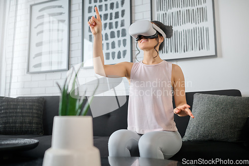 Image of Virtual reality, metaverse and gaming with a woman in the living room of her home using a headset to access a 3d game. Futuristic, vr and technology with a female gamer using ai to play online games
