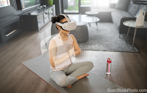 Image of Virtual reality, meditation and fitness with a woman using a headset to access the metaverse in her home for health. VR, yoga and exercise with a young female yogi meditating in her house using 3d ai