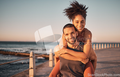 Image of Fitness, beach and portrait of couple piggyback enjoy holiday, vacation and quality time on weekend. Love, summer and black man and woman relax after running, exercise workout and training by ocean