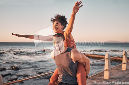 Image of Sunset, relax and couple piggyback by ocean enjoying holiday, vacation and quality time on weekend. Love, freedom and happy black man and woman after exercise, fitness workout and training by sea