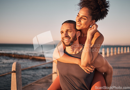 Image of Beach, sunset and couple piggyback in summer enjoying holiday, vacation and quality time on weekend. Love, dating and black man and woman relax after running, fitness workout and training by ocean