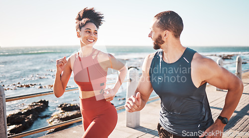 Image of Running, fitness and water with a sports couple outdoor during summer for cardio or endurance exercise. Health, training and ocean with a man and woman runner on a promenade for a workout together