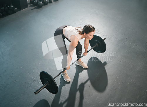 Image of Gym exercise, barbell deadlift and woman doing muscle fitness performance, workout or body building. Strong girl, health lifestyle and top view of strength training athlete, person or bodybuilder