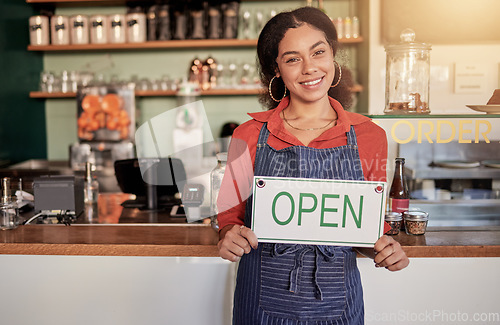 Image of Small business, portrait or black woman with an open sign to welcome sales in cafe or coffee shop. Marketing, female manager or happy entrepreneur smiles while advertising or opening a retail store
