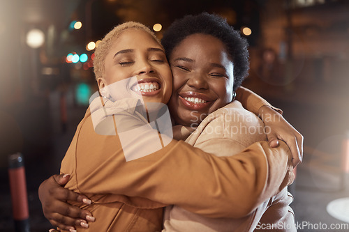 Image of Women, bonding or hug in city night, party event or late social for birthday celebration, New Year or road festival. Smile, happy or friends embrace, support or trust on dark urban street in fashion