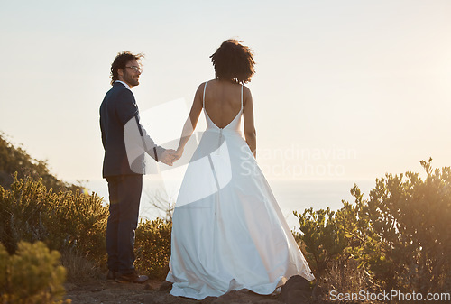 Image of Love, wedding and holding hands with couple in nature park for celebration, romance and happiness. Sunset, support and summer with bride and groom in countryside for marriage, ceremony and bonding