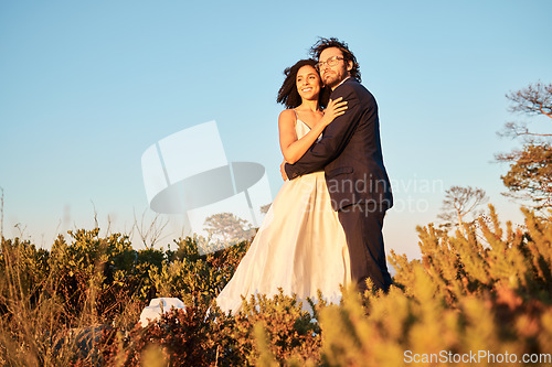 Image of Bride, groom and wedding in nature at sunset by interracial couple, happy and excited for love, romance and relationship. Marriage, woman and man embracing at outdoor ceremony, in love and sweet joy