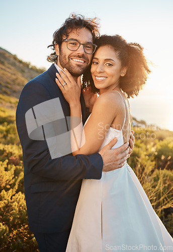 Image of Portrait, interracial and bride with groom for wedding at sunset in nature, hug and celebrate love and relationship. Face, couple and marriage by black woman and man smile, hug and happy