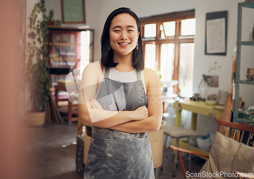 Image of Woman, potter or arms crossed portrait in pottery studio, small business or Asian ceramic workshop. Smile, happy or clay product worker and confidence, vision ideas or goals for creative store design