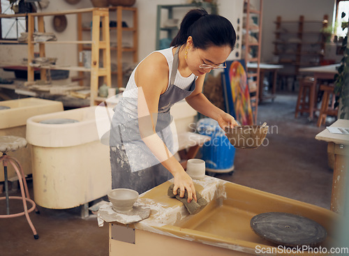 Image of Pottery, startup business and woman cleaning in workshop for art class, production and manufacturing. Asian artist at creative potter workplace for clay or ceramic school, trade or process with pride