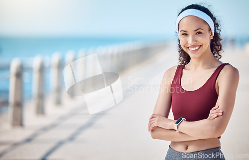 Image of Happy woman, portrait and fitness with arms crossed at beach promenade for exercise, wellness and mockup in Miami. Female athlete, smile and standing at seaside for workout, summer training or sports