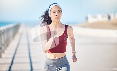 Image of Woman running at beach promenade for fitness, energy and strong summer body. Female runner, sports person and athlete at seaside for marathon, cardio exercise and healthy wellness workout in sunshine