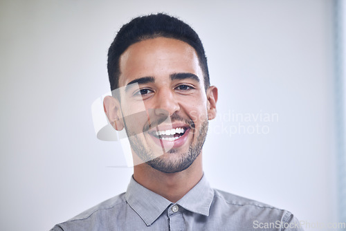 Image of Businessman, portrait and face of a worker in a office ready for working. Happy, smile and work employee from London in creative tech designer company feeling calm in workplace with job happiness