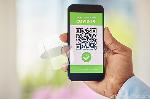 Image of Coronavirus, vaccine and mobile certificate for travel, trip or medical certification on a phone. Technology, healthcare and closeup of hand with app for covid with barcode for immunity vaccination.