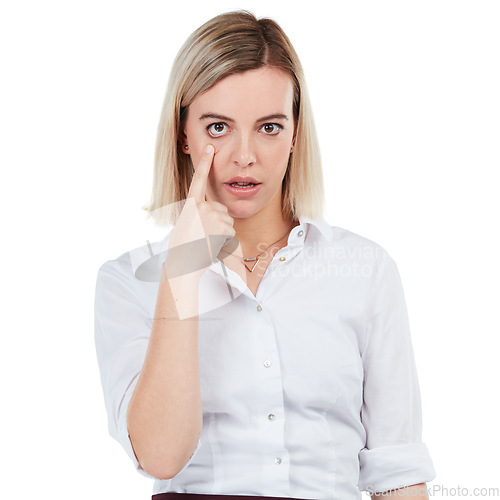 Image of Portrait, eye and serious with a business woman in studio isolated on a white background showing her eyeball. Face, vision and pointing with a female employee making a rude gesture on blank space