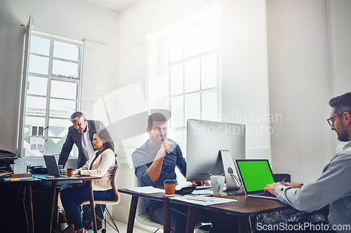 Image of Portrait, teamwork and business man by computer in office workplace. Laptop, mockup green screen and young male employee working on marketing, advertising or sales project with people or coworkers