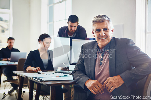 Image of Senior, portrait and business man in office or company workplace. Leadership, ceo and happy elderly male employee or manager with colleagues working on marketing report, advertising or sales project.