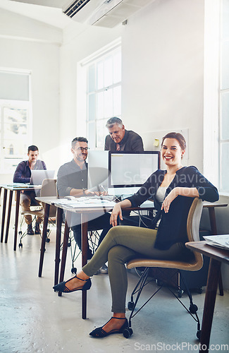 Image of Teamwork, portrait and business woman in office workplace ready for targets or goals. Leadership, ceo and happy female manager sitting on chair with coworkers working on sales or advertising project.