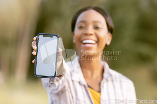 Image of Mockup, smartphone and black woman in nature or park with happy portrait for mobile app or product placement. African person, hand holding phone and mock up screen, space and 5g technology in garden