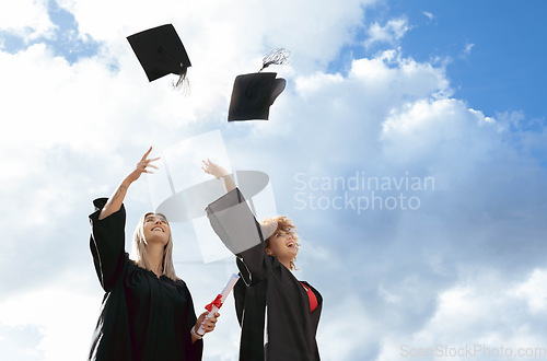 Image of Graduate women, friends and cap in air for celebration, happiness or success for studying together at campus. University student, black woman and diversity for goal, vision and achievement at college