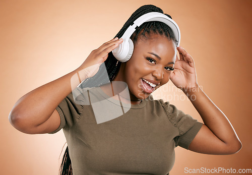 Image of Headphones, music and black woman in portrait isolated on studio background for mental health, energy and podcast. Happy african person listening to audio technology with smile on face for sound
