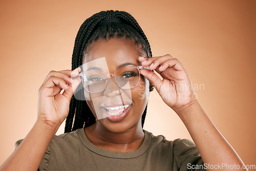 Image of Black woman, portrait smile and glasses for fashion, style or smart casual against a studio background. Happy African American female model face smiling for eyewear, spectacles and sight or vision