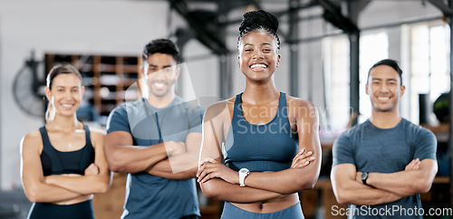 Image of Fitness, portrait and woman personal trainer with a team standing with crossed arms in the gym. Sports, collaboration and happy people after exercise, workout or training class in sport studio.