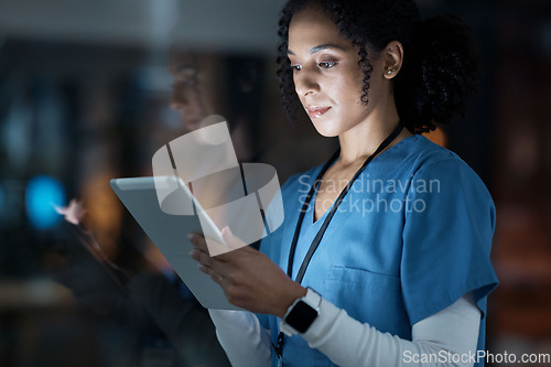 Image of Medical, research and night with doctor and tablet for planning, medicine and schedule. Technology, review and digital with black woman reading report for healthcare, science and life insurance news