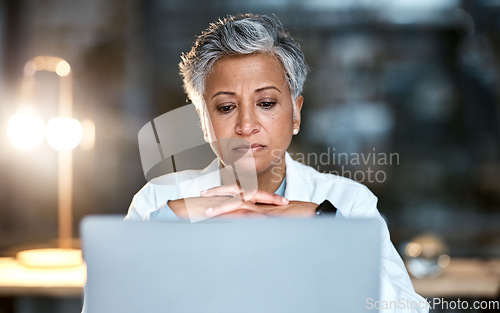 Image of Senior woman, doctor and laptop at night thinking for healthcare solution, idea or strategy at hospital. Elderly female medical expert working late on computer and contemplating decision or choice