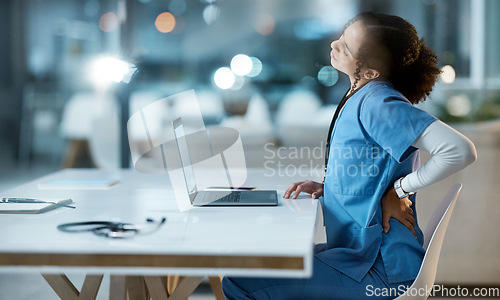 Image of Laptop, back pain and doctor in her office at the hospital working on a diagnosis or cure. Computer, healthcare and female medical worker with a muscle sprain, ache or inflammation at medicare clinic