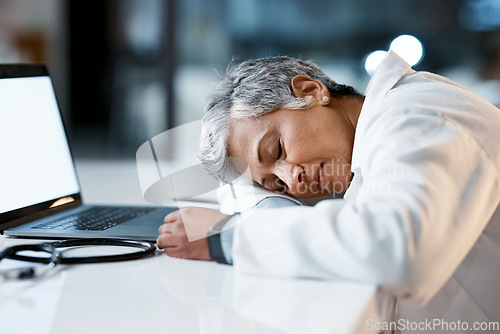 Image of Healthcare, overtime and doctor sleeping at laptop, burnout and exhausted from research with mockup. Stress, sleep and woman in medicine at desk, tired and napping at work late at night in hospital.