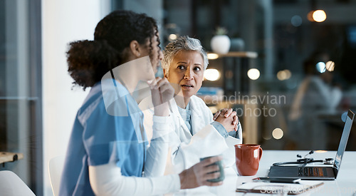 Image of Doctor, team and laptop in discussion at night for healthcare strategy or planning at hospital. Women medical professional in collaboration working late together for teamwork, conversation or ideas