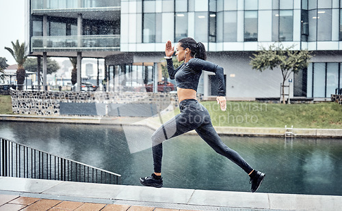 Image of Run, rain and black woman with fitness, workout and training for marathon, wellness and healthy lifestyle. Wet, African American female athlete and runner outdoor, practice and balance for energy