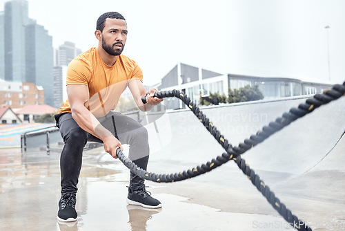 Image of Outdoor, exercise and man with ropes, workout or training for wellness, fitness or healthy lifestyle. Outside, male or athlete swinging battle ropes, body care or intense movement for energy or power