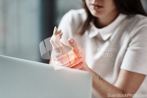 Image of Laptop, pain in hand and woman in office with wrist injury from writing, typing and working on computer. Stress, medical care and girl worker touch hands with carpal tunnel, muscle ache and arthritis