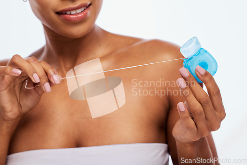 Image of Dental, floss in hands and black woman, flossing for teeth whitening, health and hygiene isolated on white background. Oral care product, skincare and mouth cleaning for fresh breath in studio