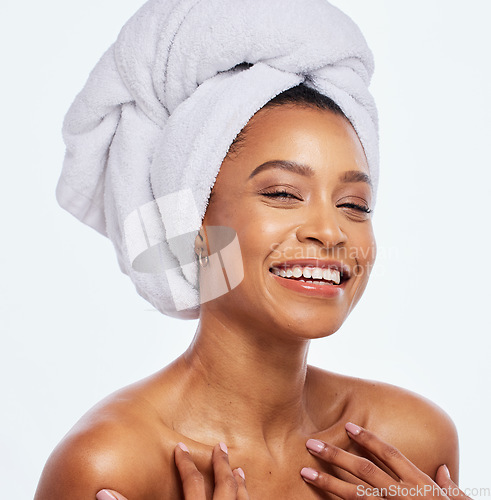 Image of Hair care, towel and woman face portrait in studio, isolated white background and facial beauty. Female model, clean shower and head cloth for happy skincare, laughing and smile for body dermatology