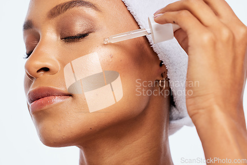 Image of Black woman, beauty and face oil for skin in studio for dermatology, cosmetics and natural skincare. Aesthetic model with collagen spa facial serum and a healthy glow isolated on a white background