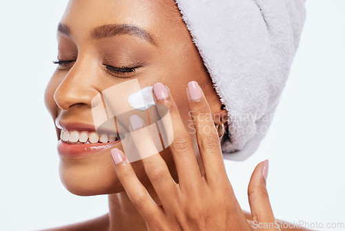 Image of Black woman, beauty and skincare cream for face in studio for dermatology and cosmetics. Aesthetic model person hand on facial product for healthy and natural glow skin isolated on a white background