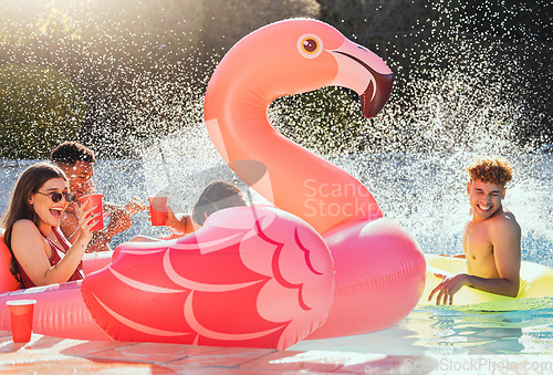 Image of Pool, flamingo and friends at a party with drinks happy in the water with a splash outdoor. Swimming, alcohol and happiness of young people celebration in sunshine for summer together having fun