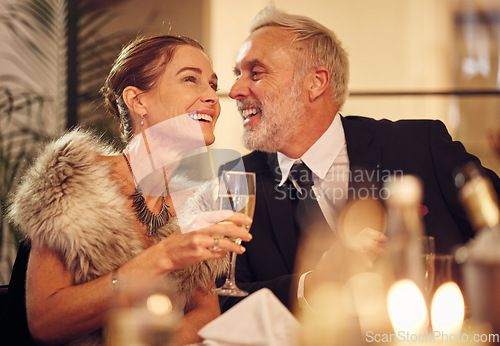 Image of Happy, senior and couple celebration dinner with wine glass and smile of woman with funny man. New years party with mature guests smiling together for joke in elegant, classy and formal style.