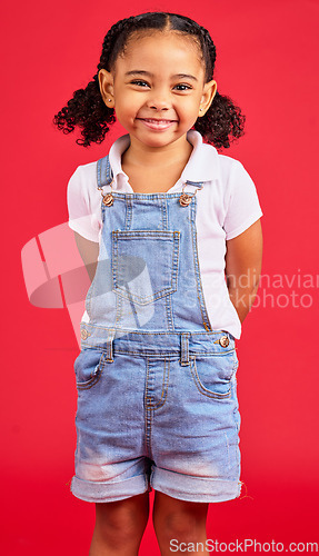 Image of Child, little and portrait of girl in studio, happy and smile on red background with mockup. Face, cheerful and trendy toddler standing against space, excited and positive, smiling and pose isolated