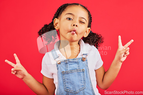 Image of Happy, peace sign and kiss with portrait of girl for summer, happiness and funny face. Meme, fashion and smile with child and hand sign for youth, comedy and positive in red background studio