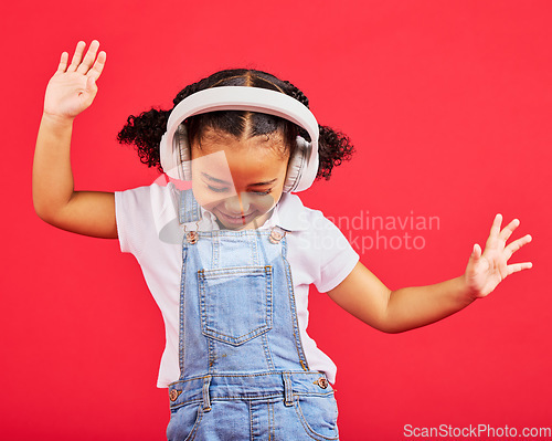 Image of Dancing, energy and kid and music headphones, fun radio and loud podcast on isolated red background or studio backdrop. Smile, happy child and girl listening to dance audio, sound and streaming media