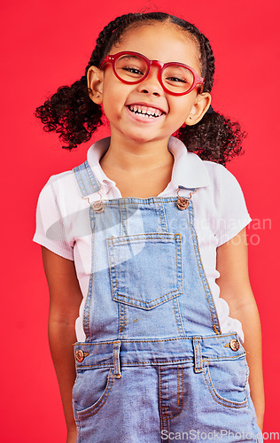 Image of Happy child, portrait or fashion glasses on red background in children style, eyes care or wellness health. Smile, kid or little girl and optometry frames for cool vision support or medical insurance