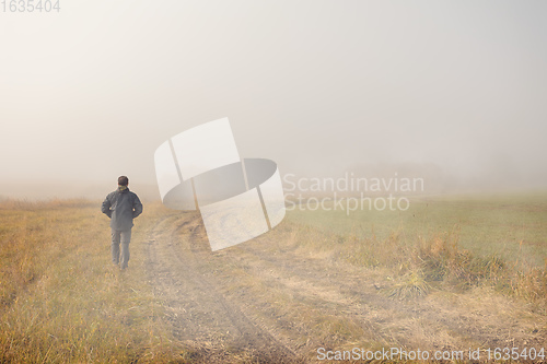 Image of men silhouette in the fog