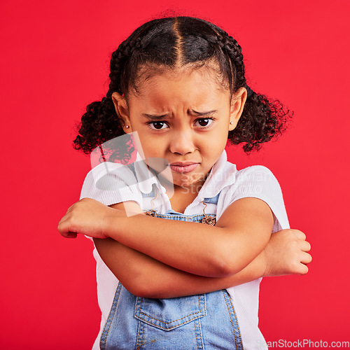 Image of Child, arms crossed or sad portrait on isolated red background for depression, mental health or crying face. Upset, unhappy or little girl with sulking, grumpy or facial expression in bullying crisis