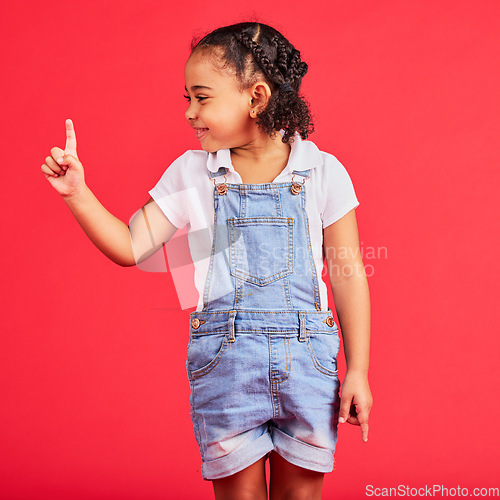 Image of Mockup, black girl and finger for space, product placement and kid on studio background. African American female child, young person and brand development for advertising, happiness and cheerful